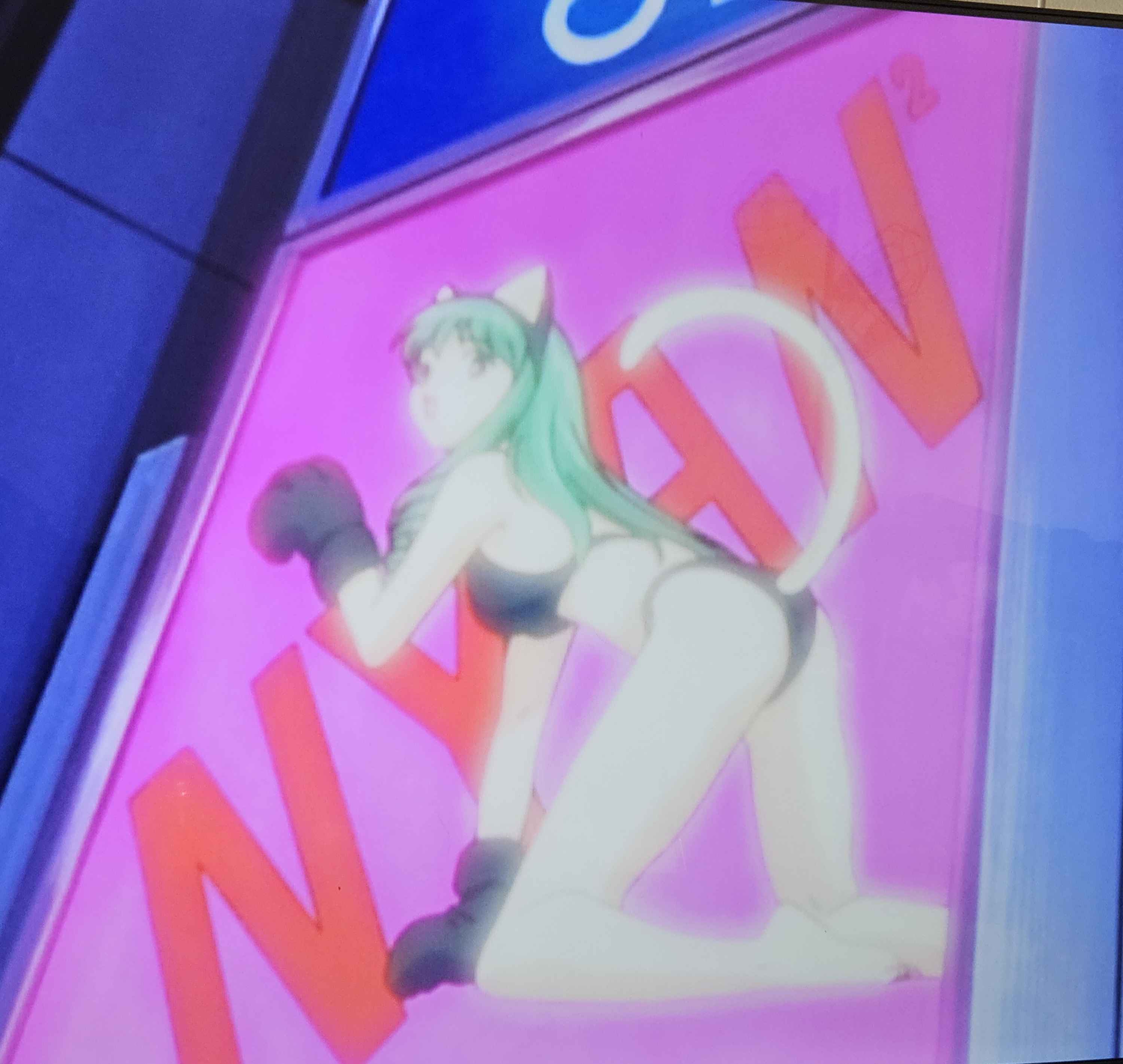 A billboard in Chobits featuring a green-haired catgirl